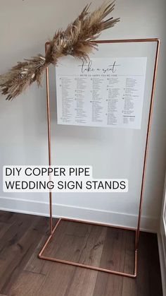 a copper pipe wedding sign stands in front of a white wall with the words diy copper wedding sign stands on it