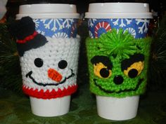 two knitted coffee cups sitting next to each other