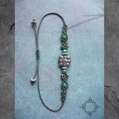 a silver chain with beads and charms on it