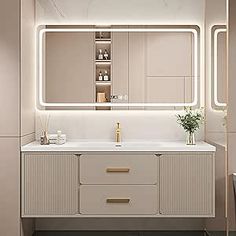 a bathroom with a sink, mirror and lights on the wall above it's counter