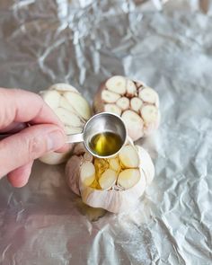 a person is pouring olive oil on some food