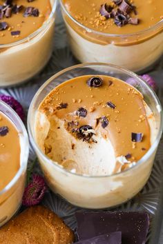 four desserts in small glass dishes with chocolate chips on the top and one is filled with ice cream