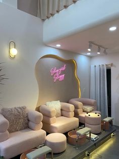 a living room filled with lots of furniture next to a large sign that says glamour salon