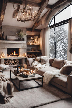 a living room filled with furniture and a fire place in front of a large window