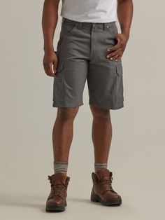 MADE TO HELP YOU BEAT THE HEAT When warmer weather strikes, our ranger workwear cargo short has you covered. Fully equipped with everything you might need on the clock, these cargo shorts come with two front pockets, lined back patch pockets, roomy side cargo pockets with flaps and concealed snaps, as well as a tape measure patch. They also feature a relaxed fit to keep you comfortable and a gusseted crotch to give you extra room where you need it most. Best of all, they’re crafted from 100% cot Wrangler Shorts, Western Shop, Western Women, Cargo Shorts Men, Beat The Heat, Jean Shirts, Cargo Shorts, Cut And Style, Mens Shorts