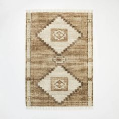 a brown and white area rug with squares on the bottom, two diamonds at the center