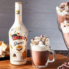 a bottle of bailey's chocolate milkshake next to a cup of hot chocolate