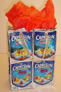 three bags of caprisun are stacked on top of each other with orange tissue