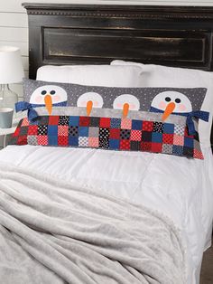 a bed with two penguins on the pillow