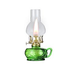 a green glass oil lamp with a light bulb on it's top and handle