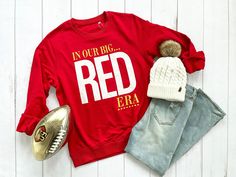 "Welcome swifties to the Red Kingdom! If you haven't heard, we have a lot going on at the moment in KC! We believe here and :13 is our lucky number. So join Andy Reed, Mahomes, Kielce and more in our Big Red Era and enjoy the show with this unisex organic sweatshirt.  The Unisex organic sweatshirt is Eco friendly, made of organic and recycled materials, and feels soft and cozy to the touch. It has set-in sleeves, 2×2 rib at collar, and a self-fabric neck tape. Order your next eco-friendly essential and hit the streets in style! We can't compliment this shirt enough - it's one of our crowd favorites. And it's sure to be your next favorite tooSIZING Most customers feel this shirt fits true to size. Please consult the size chart in the listing images.Measurements are provided by our suppliers Red Winter Fan Gear Tops, Red Sweatshirt For Fall Fan Merchandise, Red T-shirt For Fall Fan Merchandise, Red Sweatshirt For Fan Merchandise In Fall, Red Sweatshirt For Fan Merchandise, Fall Season, Red Team Spirit Tops For Winter, Red Tops For Fall School Spirit, Red School Spirit Tops For Fall, Red Long Sleeve T-shirt For School Spirit