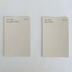 two swatches of white paint sitting side by side on a table with the same color