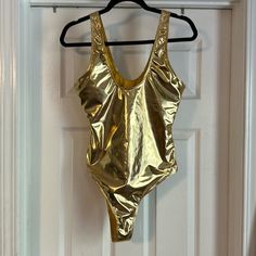 Shein Metallic Gold One Piece Swimsuit. Size L. Never Worn. Summer Metallic Sleeveless Bodysuit, Metallic Sleeveless Bodysuit For Summer, Chic Gold Stretch Swimwear, Metallic Swimsuit For Beach In Summer, Gold Beachwear Bodysuit For Swimming, Metallic Bodysuit For Summer Party, Metallic Fitted Bodysuit For Summer, Gold Stretch Sleeveless Bodysuit, Gold Stretch Bodysuit For Summer