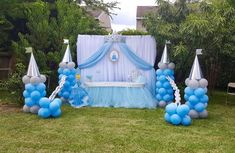 blue and silver balloon decorations in the backyard for a baby shower party or birthday celebration