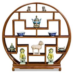 a wooden shelf with figurines and bowls on it