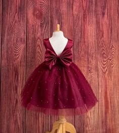 Our enchanting Knee Length flower girl dresses are sure to turn heads! This beautiful elegant sophisticated dress is handmade, the bodice consists of Burgundy Bridal Satin with a sowed in sash at the waist, the back of the dress consists of an open V-back with a hidden zipper. The big bow is detachable. The skirt consists of 4 layers of tulle with the top layer consisting with sowed in pearl beads. The fifth layer is made of lining with crinoline for fullness.  This dress is perfect for any occasion!  Dress Is Pictured with a petticoat NOT INCLUDED https://www.etsy.com/listing/1316417982/white-knee-length-petticoat-wedding?click_key=41cb8b0ae4587efa582b0a433f3f5e0cde12aec0%3A1316417982&click_sum=af1df37b&ref=shop_home_active_1 Visit our store, more items to come!  https://www.etsy.com/shop Christmas Flower Girl Dresses, Childrens Party Dresses, Burgundy Flower Girl Dress, Red Flower Girl Dresses, Summer Princess, Holiday Photoshoot, Wine Dress, Toddler Summer, Elegant Sophisticated