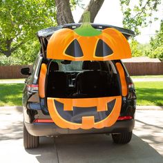 the trunk of a car decorated to look like a pumpkin