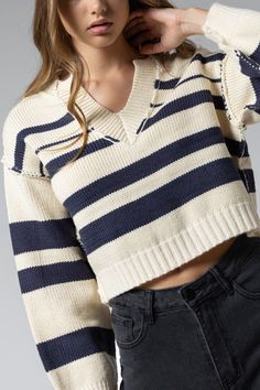 The "Penelope" sweater is crafted from a high quality, soft blend of navy and tan for the utmost in comfort and style. Its timeless appearance makes it an ideal addition to any wardrobe. Casual Navy V-neck Sweater For Fall, Fall Cream Cropped Sweater, Navy Casual V-neck Sweater For Fall, Cream Knit Polo Sweater For Fall, Navy Cotton Textured Knit Sweater, Navy Sweater For Layering In Fall, Navy Sweater For Fall Layering, Cozy Navy Tops For Fall, Navy Knit Sweater For Layering