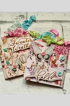 two handmade cards with flowers and butterflies on them, one has a name tag