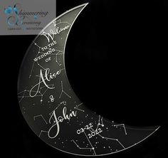 a glass moon with writing on it and stars in the night sky behind it is shown