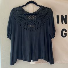 a black blouse hanging on a white wall