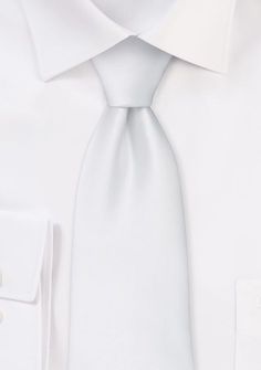 Exude timeless elegance with our White Solid Necktie. This captivating accessory epitomizes sophistication and refinement. The pristine white hue adds a touch of purity and class to any ensemble, making it an essential choice when shopping for mens suits or seeking the perfect accent for a dashing tuxedo look. Whether you're attending a wedding or a formal event, this necktie exudes a classic and sophisticated charm. Its solid design allows for effortless pairing, complementing a range of suit c Elegant Ties For Black Tie Events, Classic Fitted Silver Suit And Tie Accessories, White Fitted Suit And Tie Accessories For Office, Elegant Silver Wedding Tie, Elegant Silver Wedding Ties, Elegant Silver Suit And Tie Accessories For Formal Events, White Business Ties, Elegant Adjustable Accessories For Black Tie Events, Elegant Adjustable Solid Ties