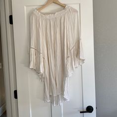 Never Worn Flowy Tunic Beach Dress For Brunch, White Flowy Skirt Midi Dress For Vacation, Flowy Summer Tunic Midi Dress, White Flowy Skirt Midi Dress For Beach, White Rayon Midi Dress For The Beach, Off White Long Sleeve Midi Dress For Beach, White Flowy Midi Dress For Beach, Flowy Sundress For Beach, Flowy Boho Tunic Dress For Day Out