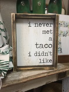 a wooden sign that says i never met a taco i didn't like