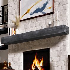 a fire place in a living room with a painting on the wall above it and a fireplace