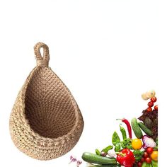 a basket with handles is next to a pile of vegetables and peppers on a white background