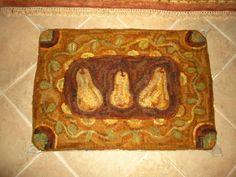 a rug with pears on it in the middle of a tile flooring area