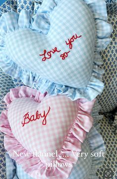 two heart shaped pillows that say i love you and baby