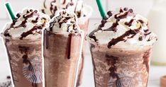 three iced coffee drinks with whipped cream and chocolate toppings