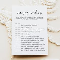 a white wedding order card sitting on top of a table