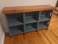 a wooden shelf sitting on top of a hard wood floor