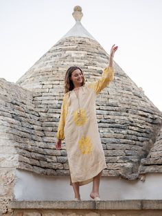 Our Palermo Maxi Dress comes intricately embroidered with vines, flowers and birds inspiring us to follow nature’s way. The tan linen and yellow stitching are the soothing, earthy tones you need this summer for exploring cobblestone streets, sitting by the pool and dining on the patio. With elastic cuffs, tassel ties and a v-neckline, you’re sure to be the most comfortable and well-dressed. Beige Linen Dress With Floral Embroidery, Linen Tunic Dress With Floral Embroidery, Bohemian Linen Embroidered Dress For Beach, Spring Bohemian Linen Embroidered Dress, Bohemian Linen Embroidered Summer Dress, Bohemian Embroidered Linen Dress For Summer, Yellow Tunic Dress With Floral Embroidery, Spring Linen Dress With Natural Dye, Casual Fall Maxi Dress