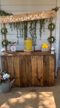 an outdoor bar with flowers and lemonade on it