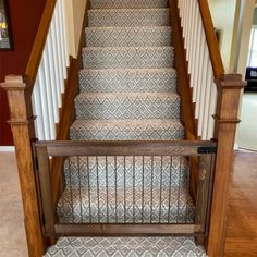 the stairs are made of wood and have decorative carpet