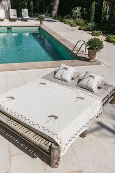 a bed sitting next to a swimming pool