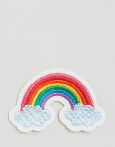 a patch with a rainbow and clouds on it