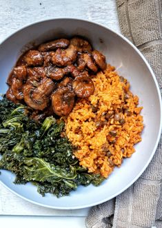 a white plate topped with rice and meat