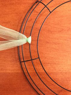 a piece of wire sitting on top of a wooden table