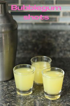 three shot glasses sitting on top of a counter