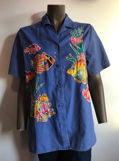 "I'm sorry but you must love tropical fish to wear this shirt. I found it in Hawaii. It's super fun with lots of colorful fish and rhinestone bubbles embroidered on the front and back. It's a button down short sleeve shirt. 55% linen 45% cotton. Size Small. My boyfriend tried it on and he's a medium and it fit. So please use the measurements compared with a similar shirt to determine fit. Label says Quacker Factory (amazing!). It does have some discoloration on front lower right (see photo) and Reverse Tie Dye, Baby Overalls, Tropical Blue, Tie Dye Shorts, Blue T, Blue Tshirt, Fishing Shirts, Nursing Shirts, Blue Shirt