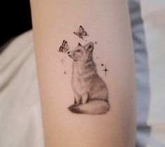 a tattoo with a fox and butterflies on it