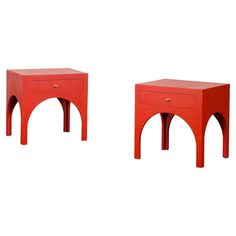 two small red tables sitting next to each other