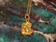 This beautiful pendant is made from a natural gold nugget that was mined in California. It is a raw, real, solid gold nugget just as found in nature. Only lightly cleaned and polished to bring out its natural beauty. Gold nuggets from this area generally average around 22k, with some natural variation depending on the exact location of their discovery. The loop added to the top is 14k gold and I am including an inexpensive 18" gold-fill chain so it will be ready to wear. The pendant weighs 2.83 Nugget-shaped Polished Jewelry As Gift, Gold Nugget Jewelry As A Gift, Untreated Recycled Gold Jewelry As A Gift, Untreated Recycled Gold Jewelry Gift, Recycled Gold Untreated Jewelry As A Gift, Hand Forged Nugget Jewelry As Gift, Polished Yellow Gold Nugget Jewelry, Yellow Gold Nugget Gemstone Jewelry, Gold Hammered Nugget Necklace