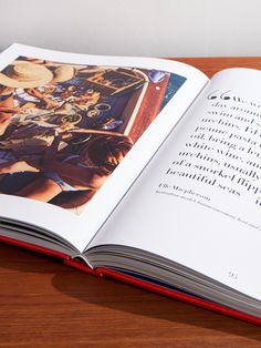 an open book sitting on top of a wooden table