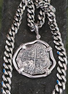 This coin is made from the silver bars recovered from the Atocha and comes with a certificate stating that. The frame is solid sterling silver and I also include a heavy duty cuban curb link chain with it that looks amazing in person, It's a beautiful piece and a striking imprint. Silver Jewelry With Curb Chain And Round Pendant, Silver Medallion Necklace With Curb Chain, Classic Silver Coin Pendant Necklace, Classic Silver Pendant Coin Necklace, Silver Medallion Coin Necklace With Polished Finish, Classic Silver Coin Necklace, Sterling Silver Hallmarked Coin Necklace, Silver Sterling Silver Coin Necklace, Key West Fl