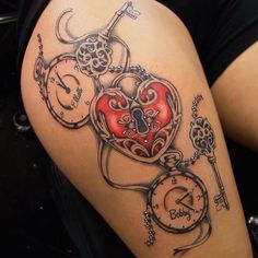 a woman's thigh with a heart and key tattoo on it